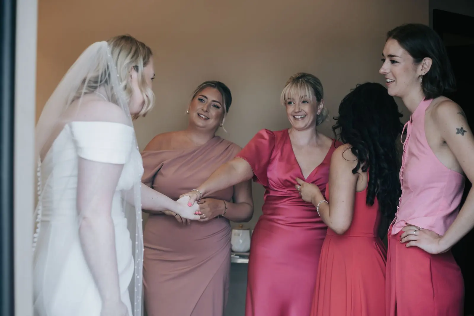 Bride with her bridesmaids in shades of pink