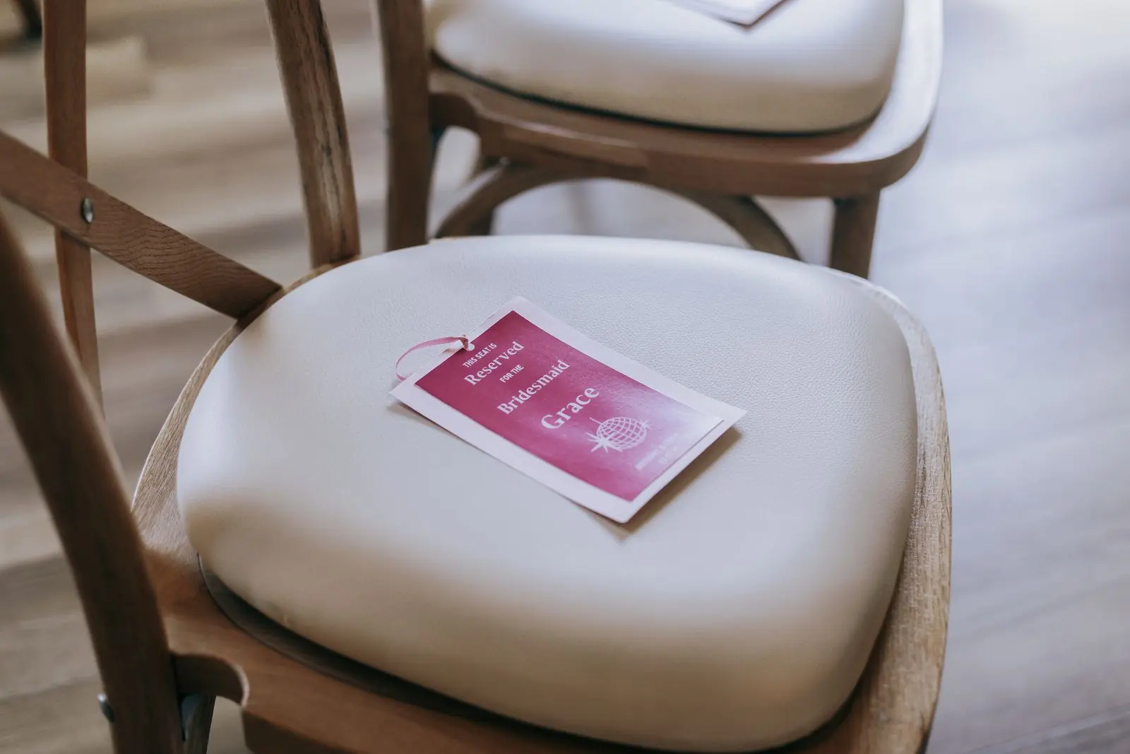 Pink name tag on a chair at the reception