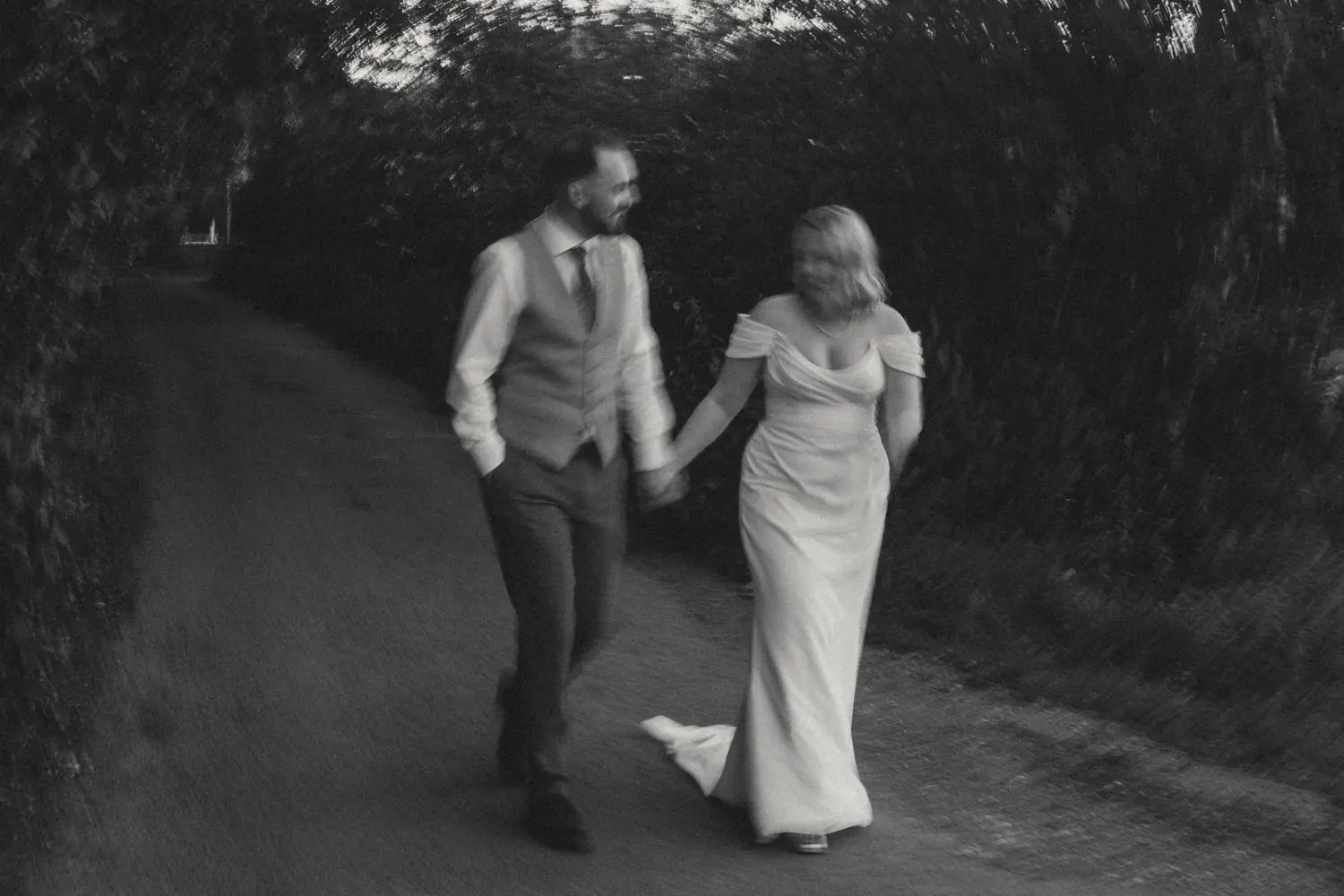 Couple walking hand in hand with motion blur on their wedding day