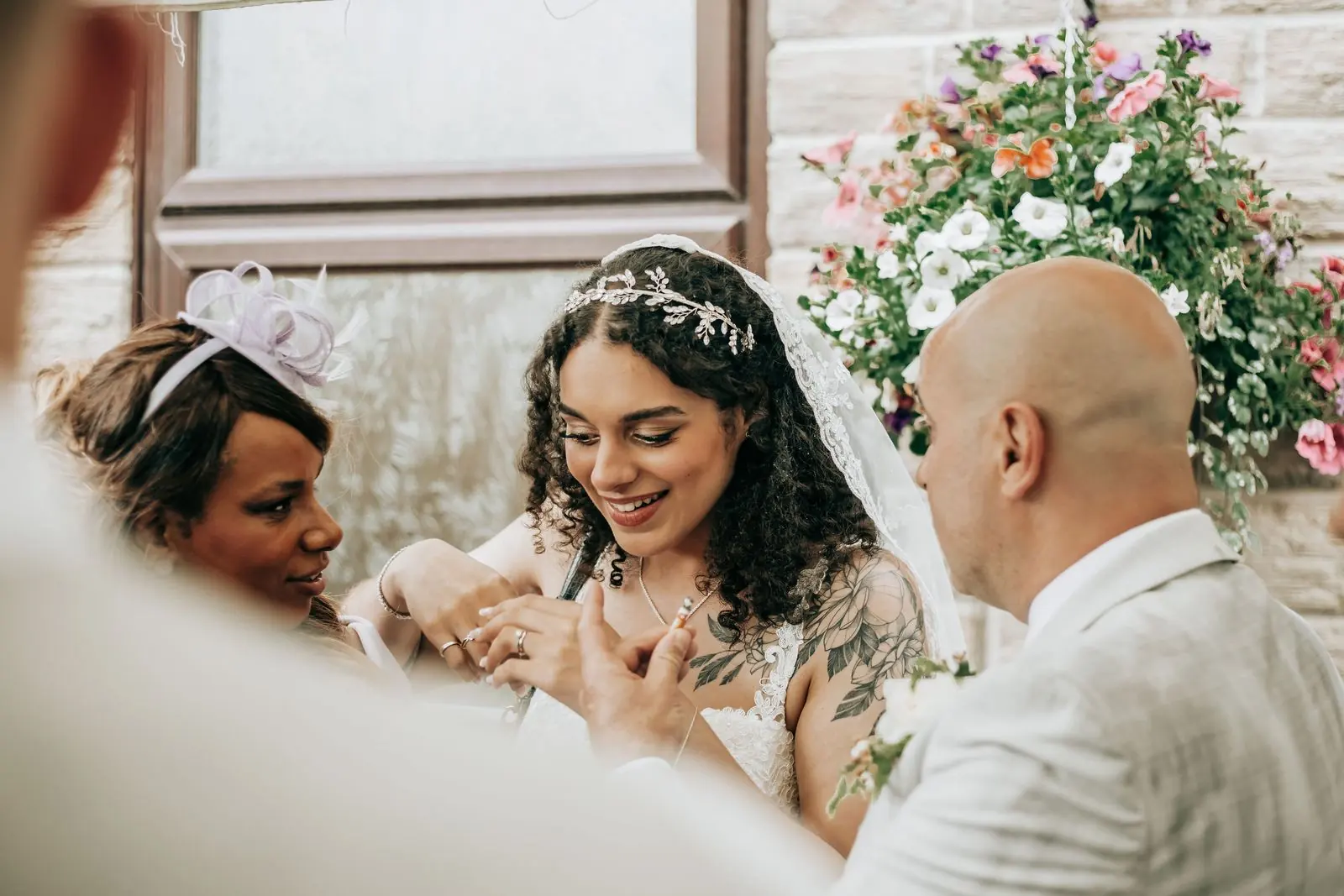 Bride smiling at a card surrounded by family